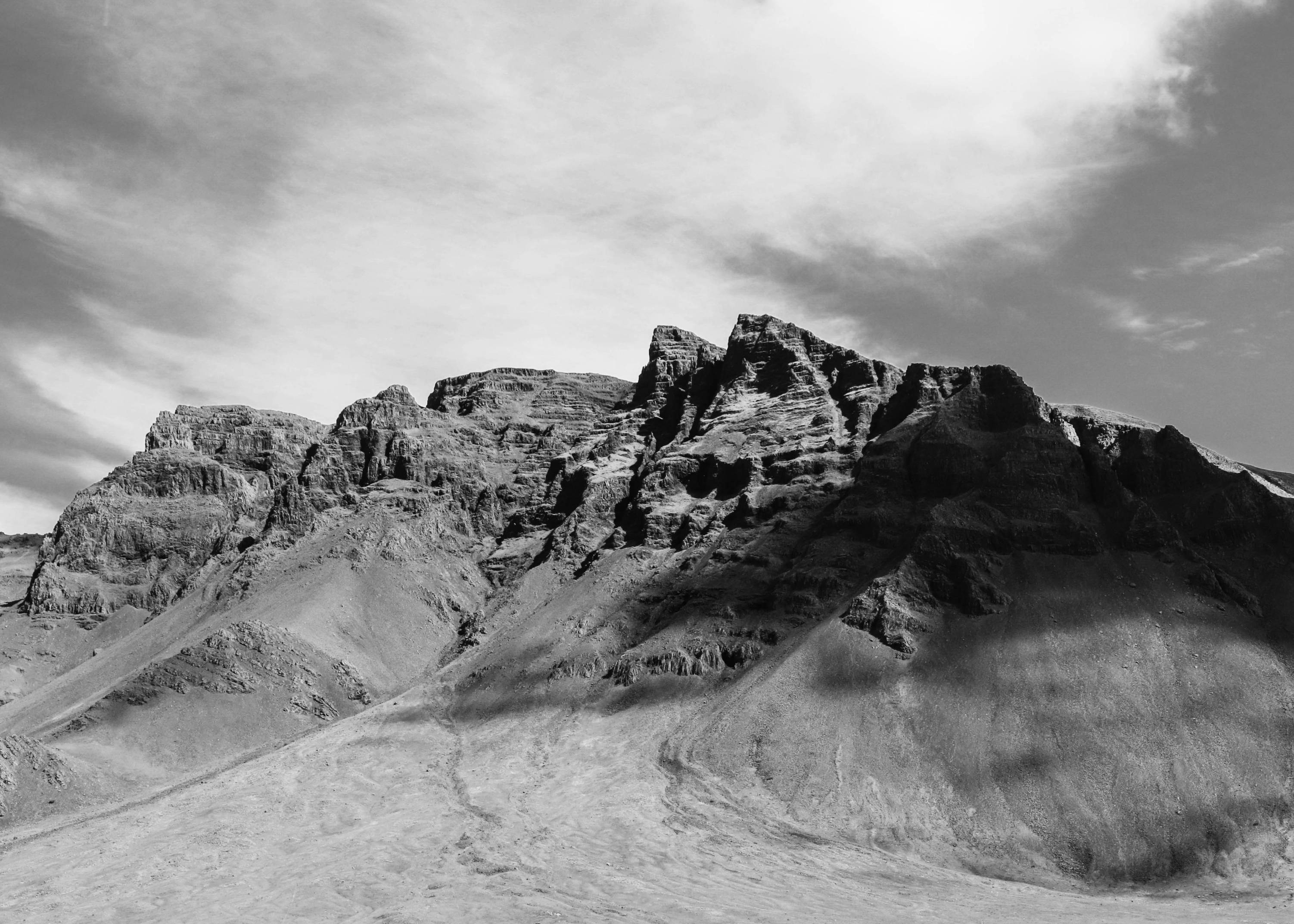 Mountain-in-iceland-black-and-white-photo-with-cloudy-skies-and-shadows-of-clouds-