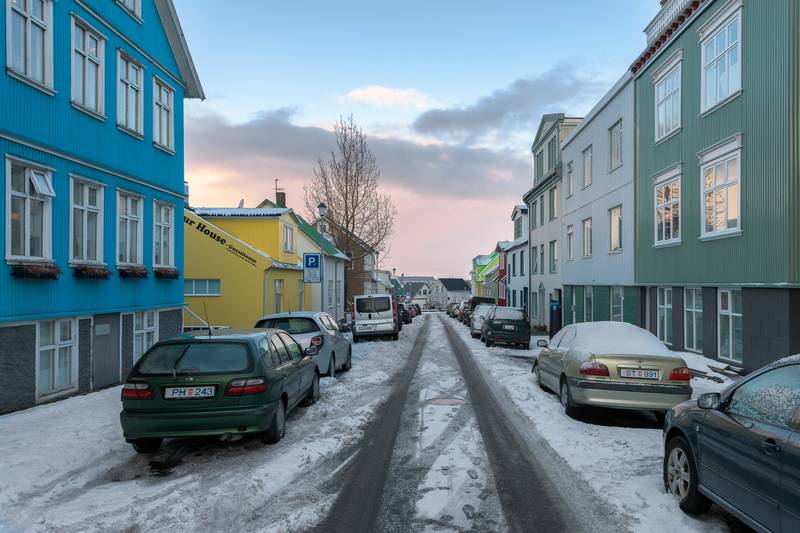 Parking-in-down-town-reykjavik-P-parking-sign-by-a-yellow-house-during-winter