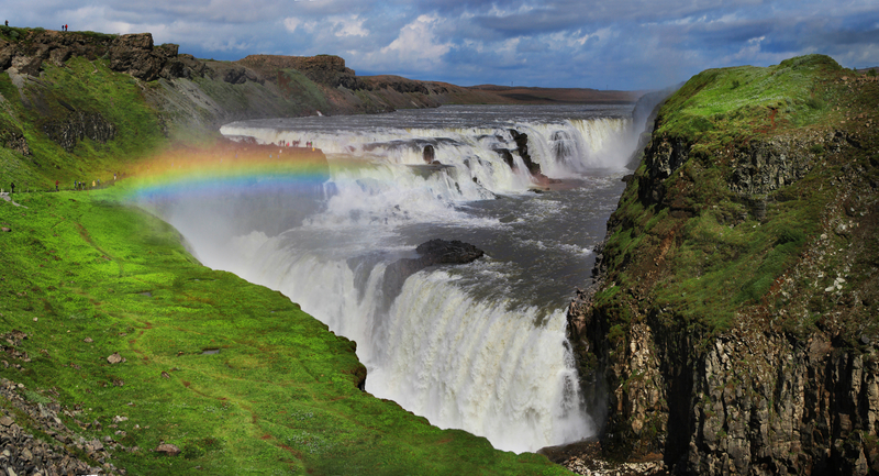 gullfoss-waterfall-in-iceland-during-summer-green-grass-bright-blue-sky-and-misty-rainbow
