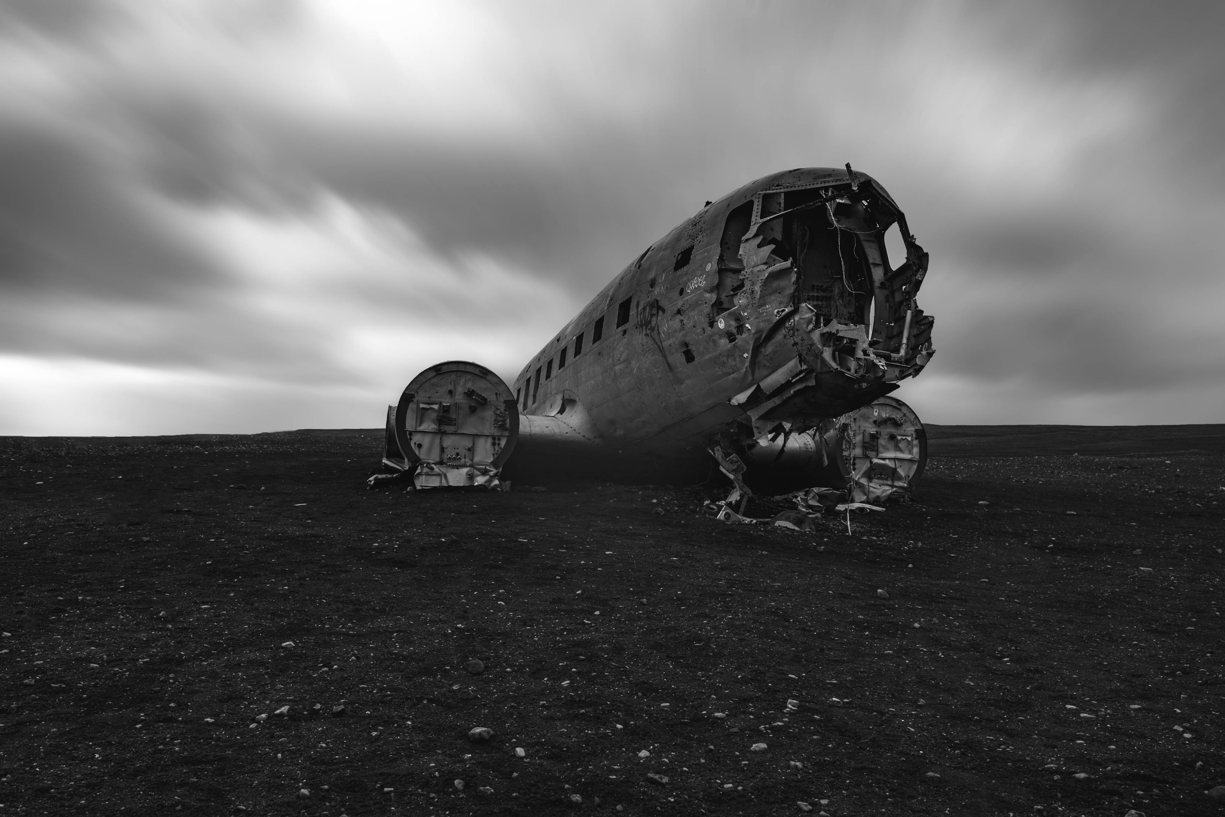 Old-Plance-wreck-in-solheimasandur-black-sand-beach-on-the-south-coast-of-iceland-in-black-and-white-moody-and-cloudy-skies-above