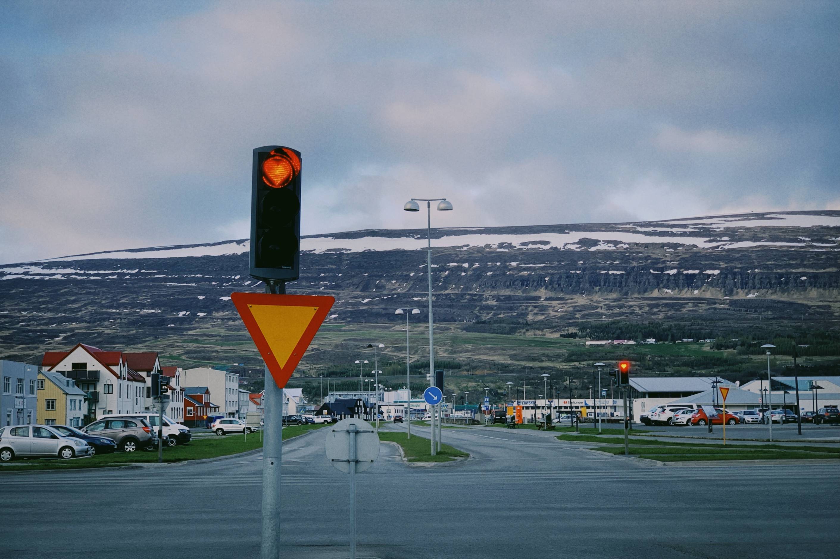 Akureyri-red-heart-traffic-light-with-mountain-in-the-background