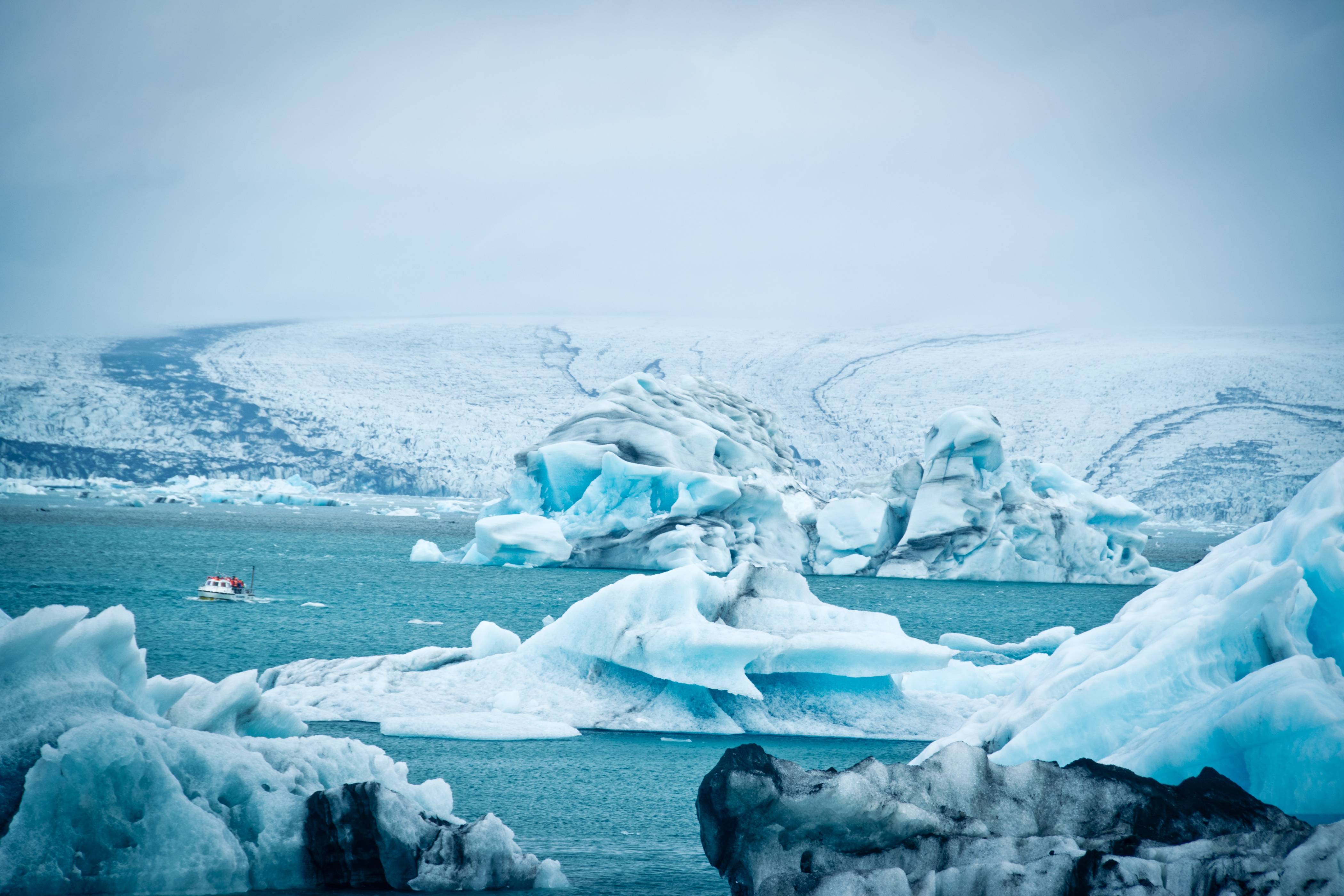 jokulsarlon-glacier-lagoon-white-icebergs-around-a-boat-with-passengers