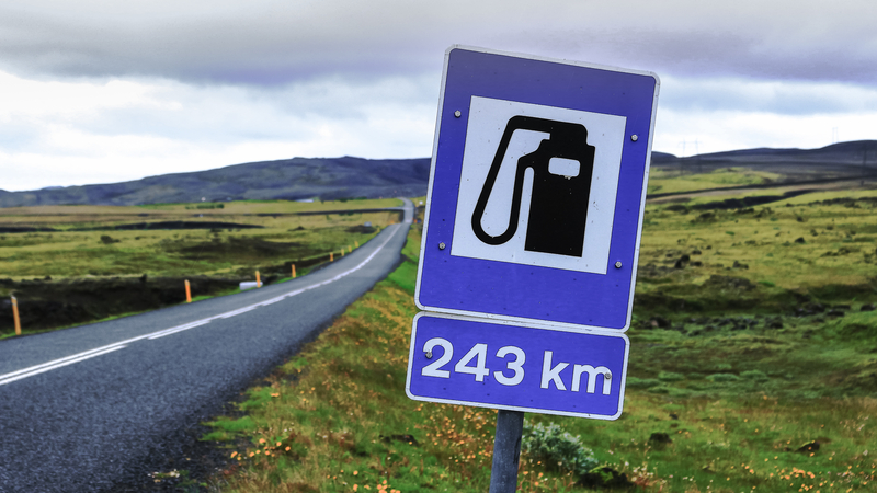 Blue-Gas-station-sign-by-country-road-in-iceland-in-summer