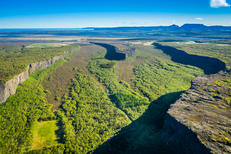 Asbyrgi-canyon-in-iceland-on-a-bright-summer-day-green-scenery-with-ocean-in-background