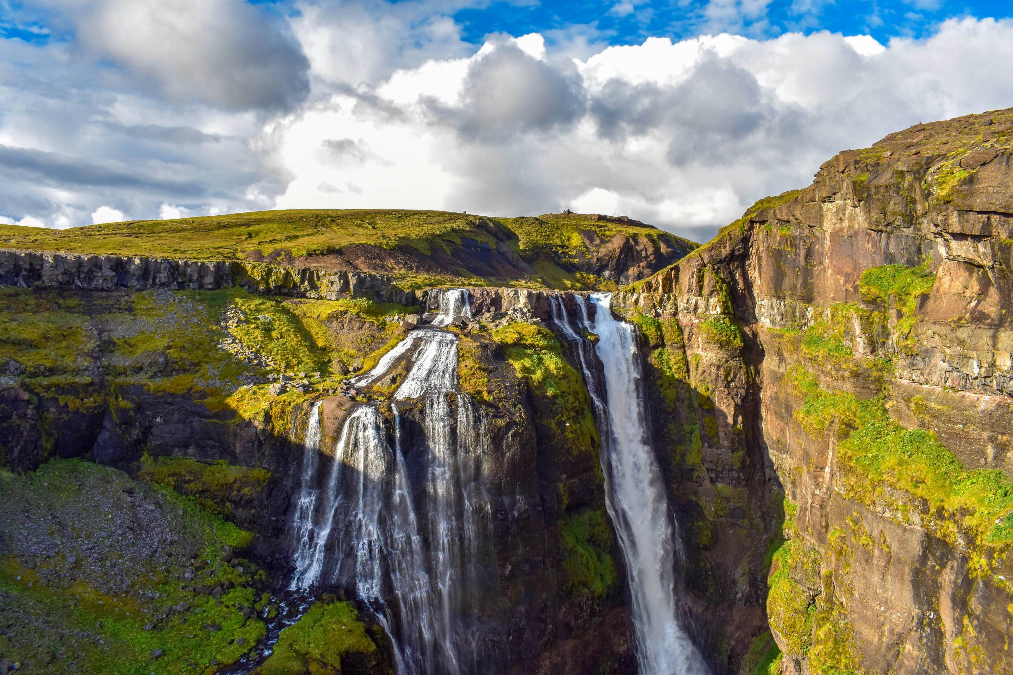Glymur-waterfall-in-Icelandic-westjords-region-in-summer-green-surroundings-and-blue-sky